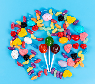 a top view lollipops and marmalades colorful tasty on the blue b